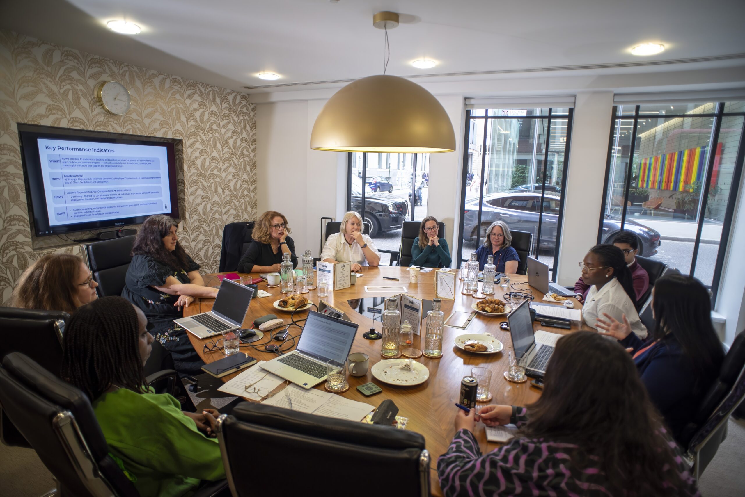 Image of a team meeting held around a boardroom table.