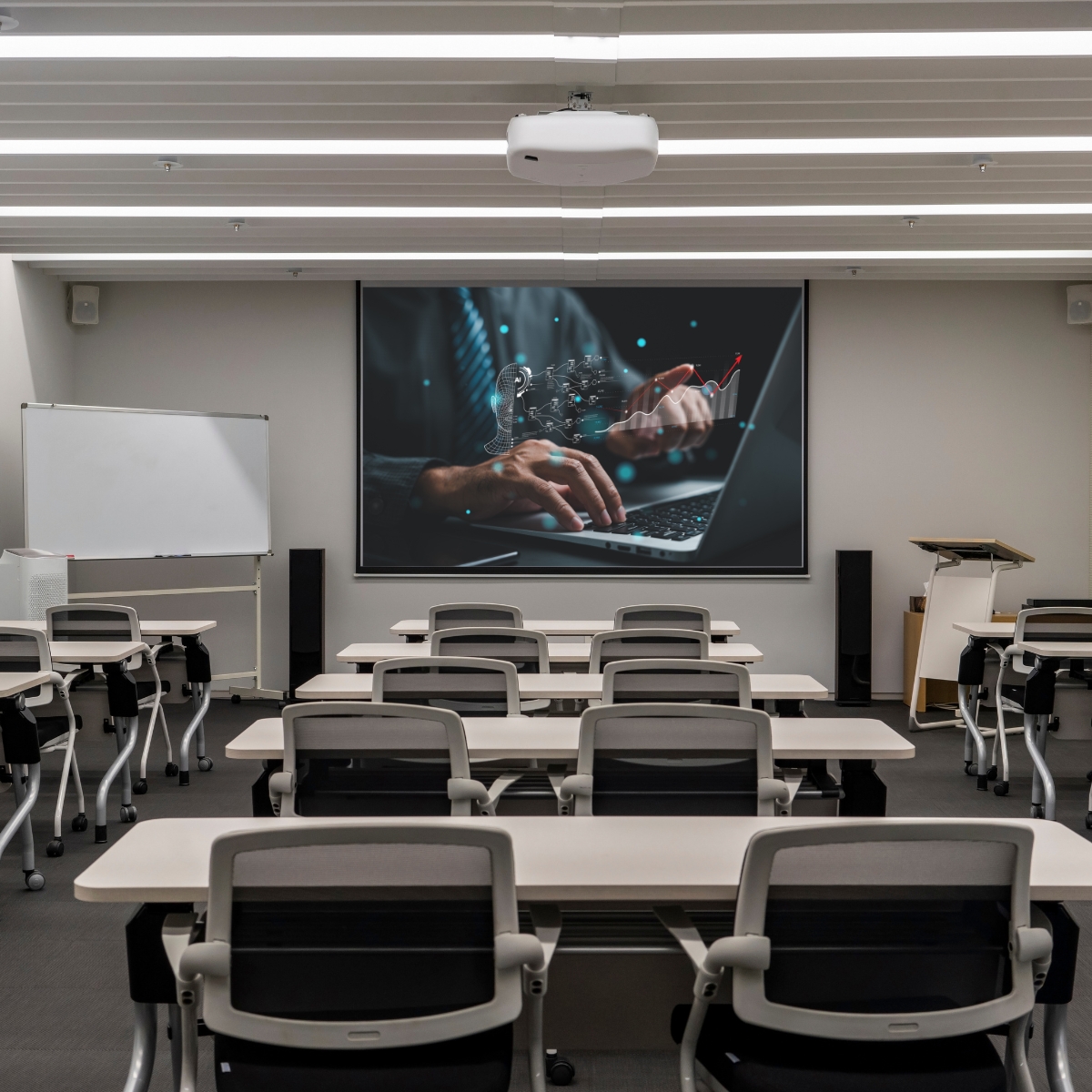 Lecture room with projector screen that has an image of a person looking at their laptop with an AI generated image overlaid on the screen.